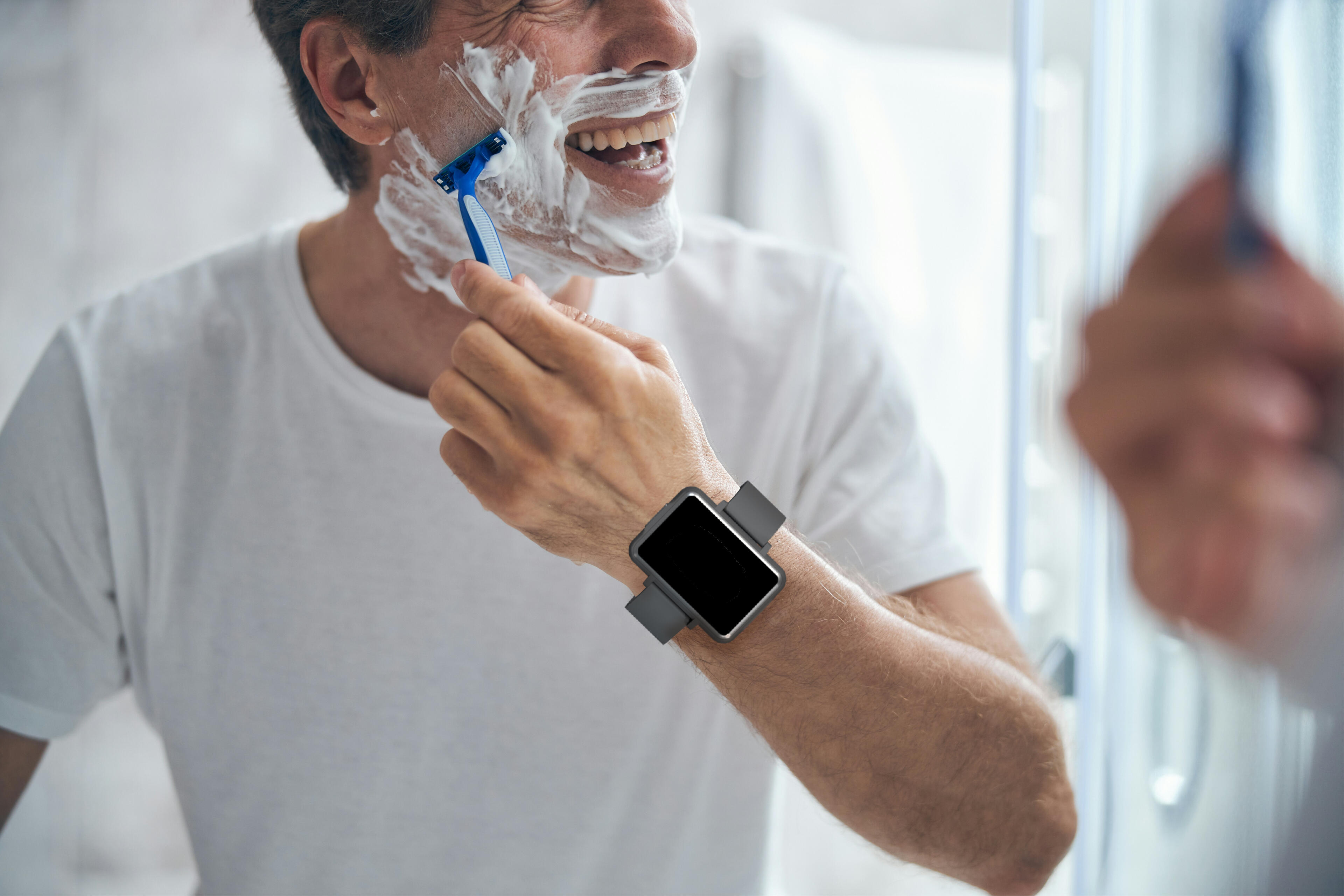 Man shaving while wearing the Cadence band.