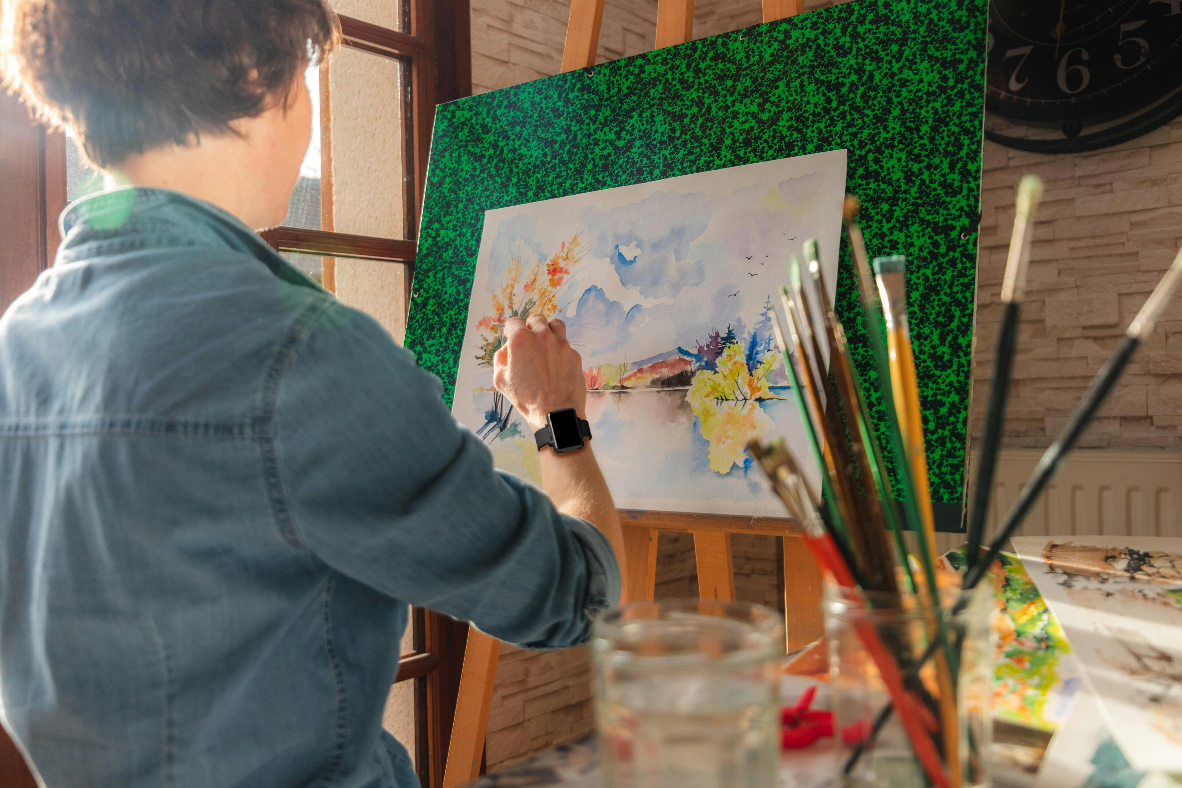 Woman painting while wearing the Cadence band.