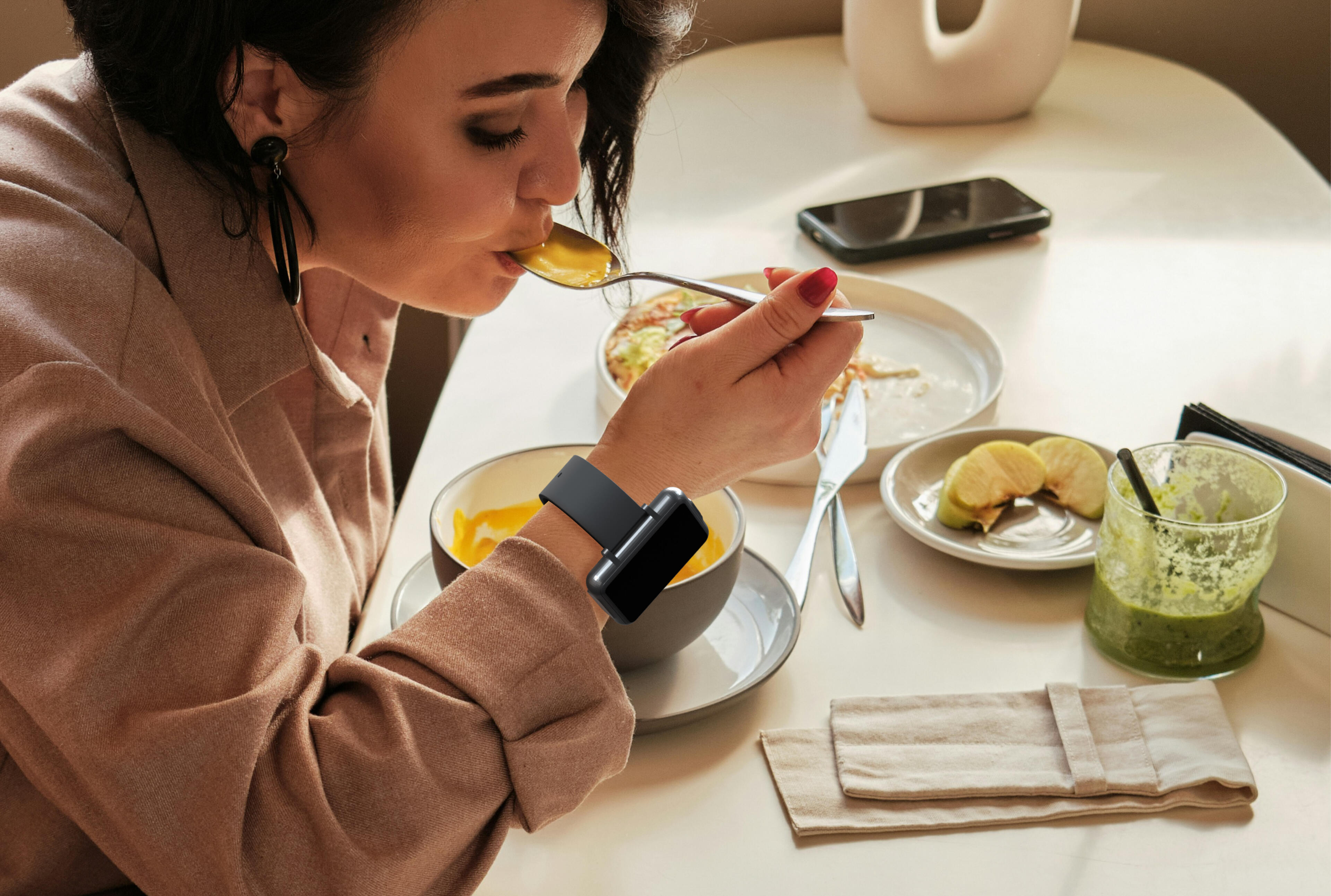 Woman eating soup while wearing the Cadence band.
