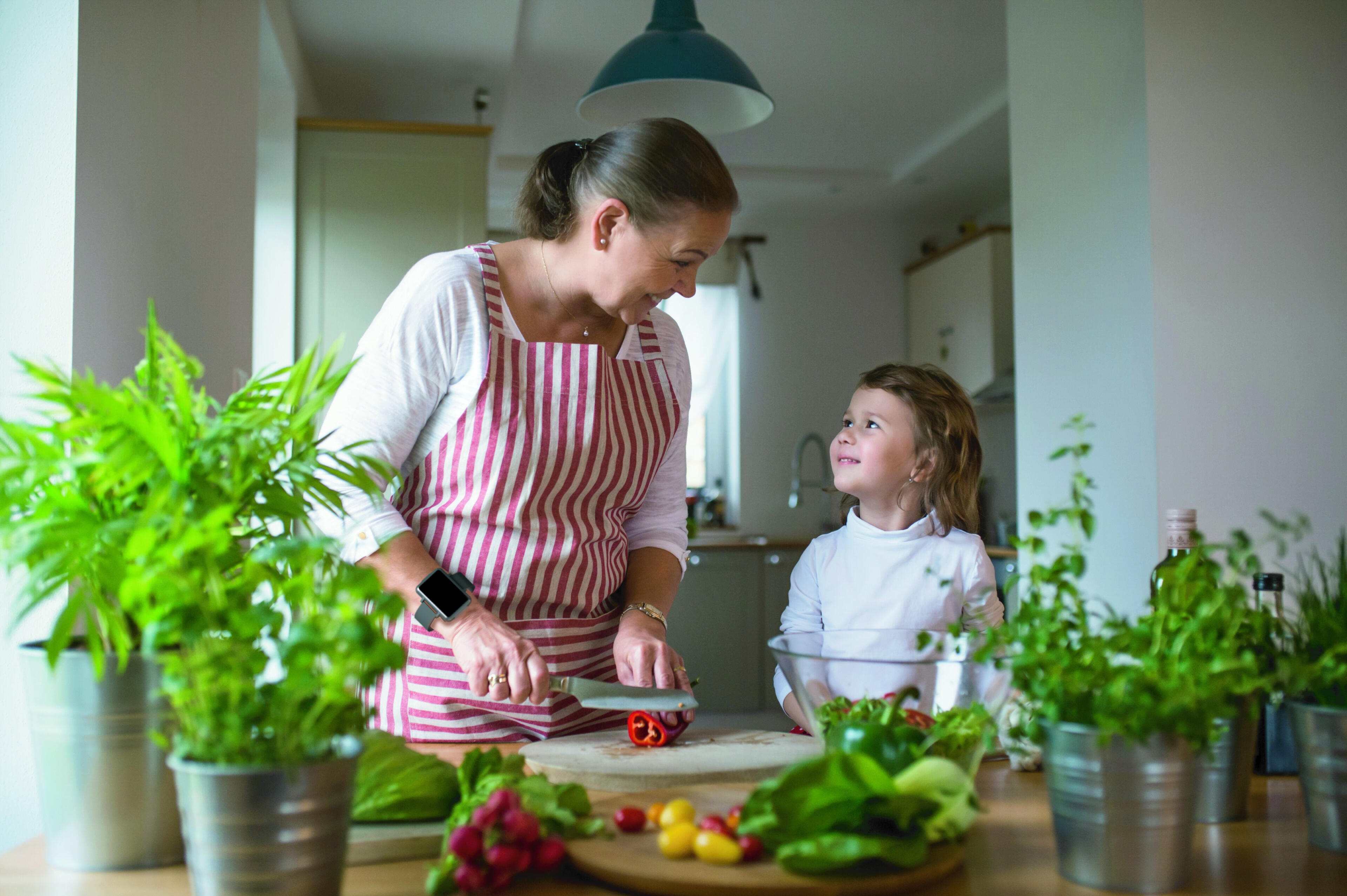 Woman cutting vegetables while wearing the Cadence band.